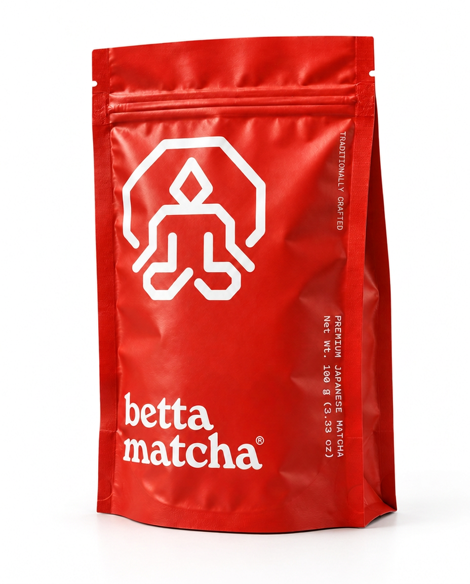 A red stand-up pouch of Betta Matcha green tea with a white geometric logo and the brand name 'betta matcha' printed on the front, set against a plain white background.